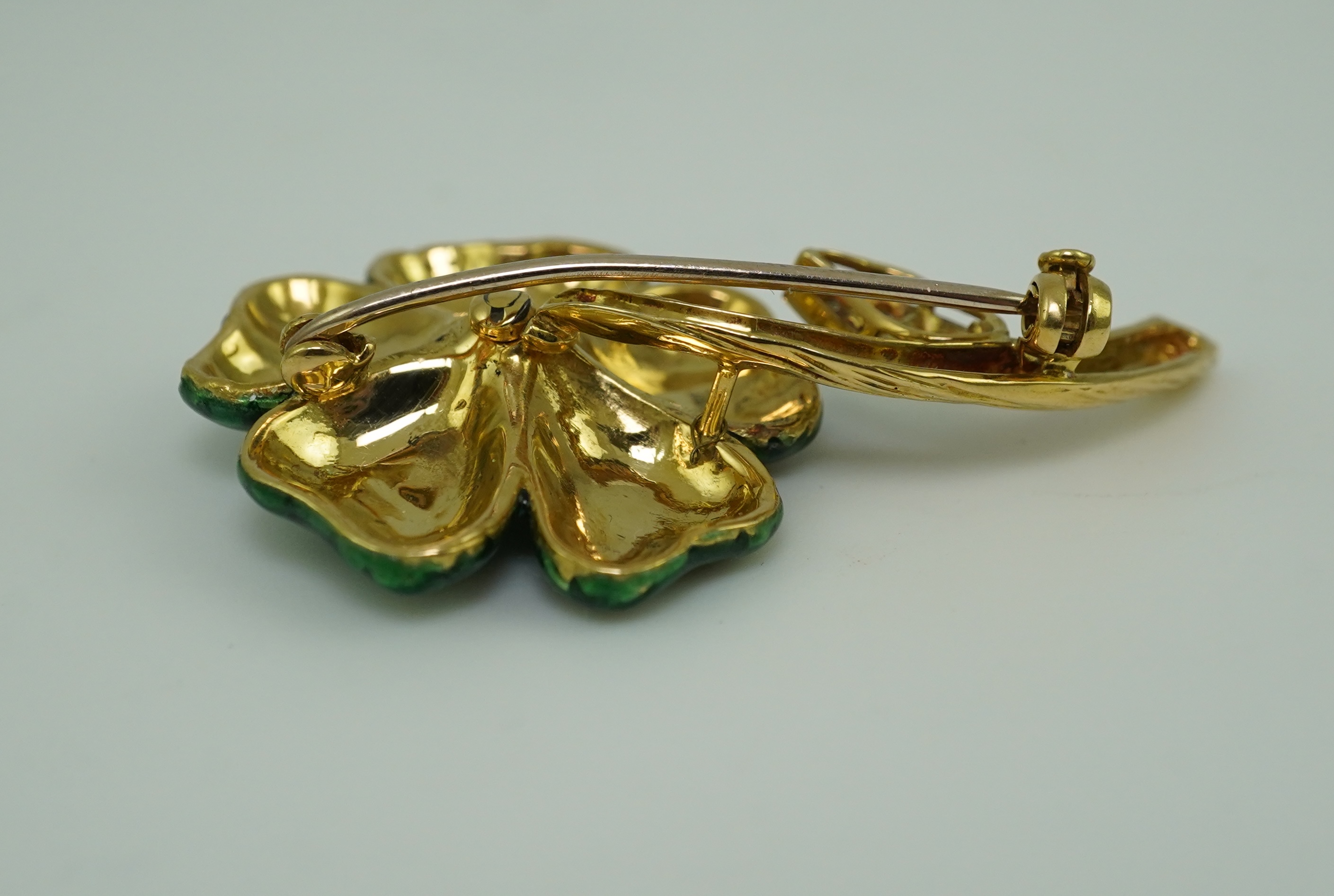 An enamel and diamond brooch